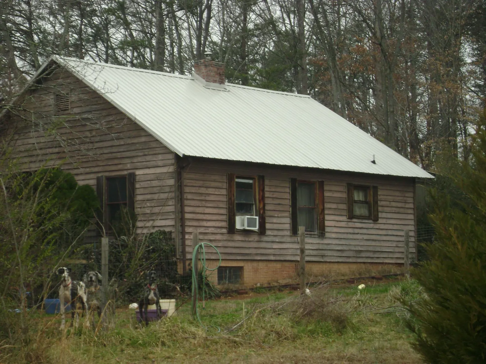White metal roof on an old wood sided farmhouse, from a Metal Roof Installation job in Midway